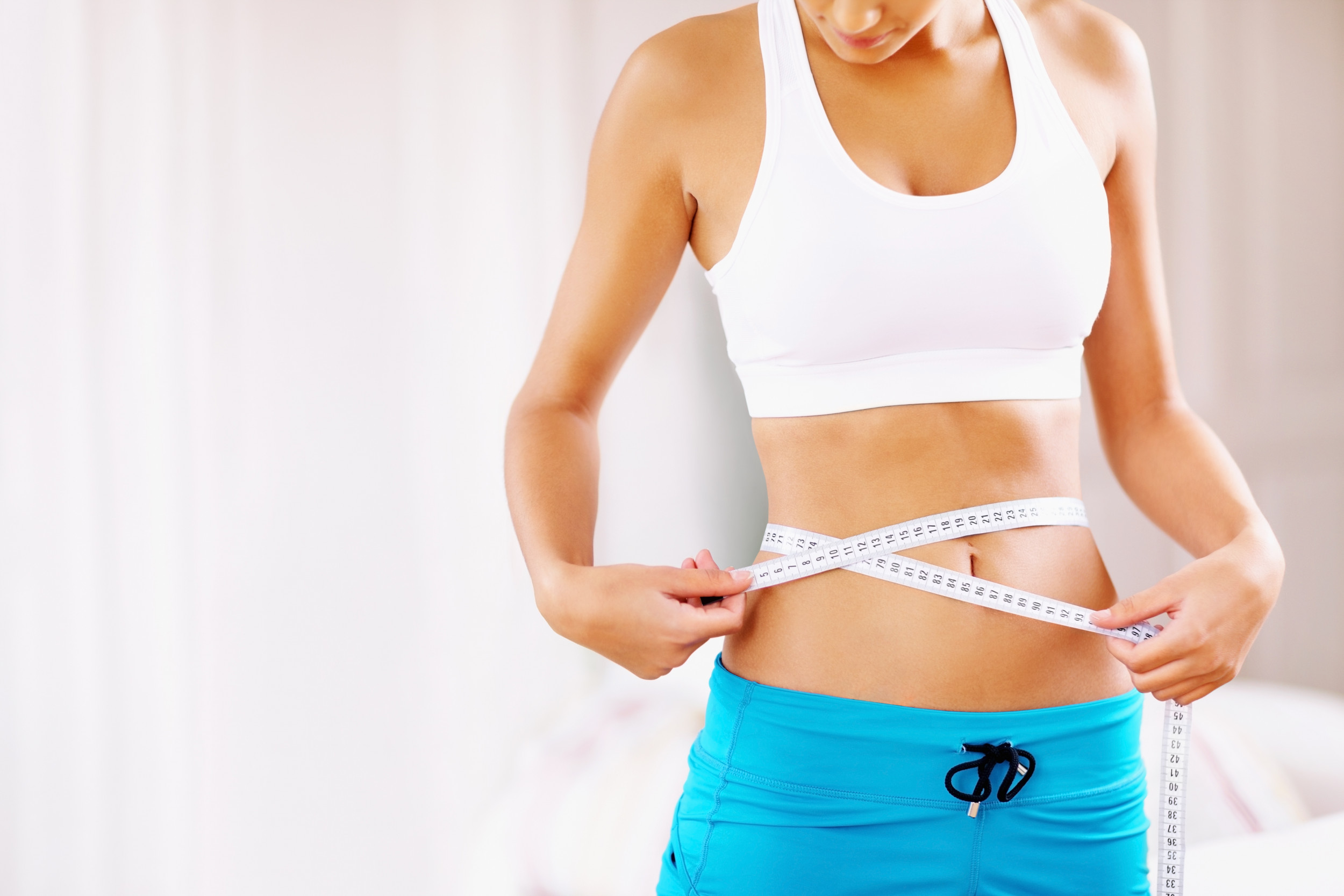 woman-holding-tape-measure-waistline.jpg
